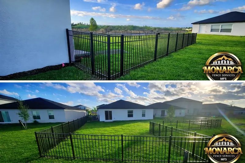 Black metal picket fencing around a green backyard with matching gates.